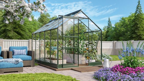 Lush greenhouse with vibrant vegetables and flowers surrounded by a well-maintained garden and outdoor seating area, perfect for gardening enthusiasts seeking high-quality greenhouses.