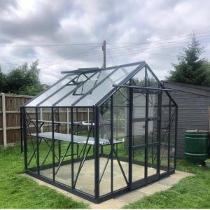 A1 Greenhouses premium glass greenhouse with black metal frame, ideal for plant cultivation and garden hobbyists, designed for optimal light and durability.