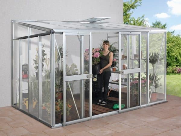 Aluminum greenhouse with sliding door, filled with vibrant flowering plants and lush greenery, designed for optimal plant growth, gardening, and outdoor cultivation.