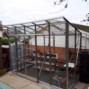 A1 Greenhouses custom glass greenhouse for home gardening and plant cultivation.