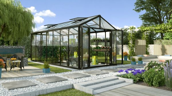 Aluminum and glass greenhouse for optimal plant growth and gardening efficiency in a beautiful landscaped garden setting.